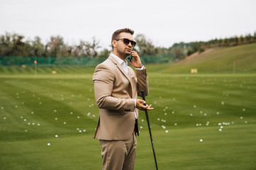 businessman talking on the phone on a golf course