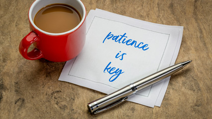 patience is key inspirational note - handwriting on a napkin with a cup of coffee