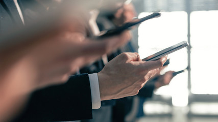 close up . image of a group of young business people with smartphones