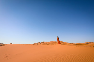 A girl in a beautiful Moroccan dress. Merzouga Morocco.