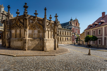 Obraz premium Picturesque historic city. Gothic stone fountain located on square in historic city. World Heritage Site by UNESCO. Kutna Hora, Czech Republic