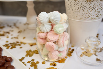 White and pink meringues in a jar