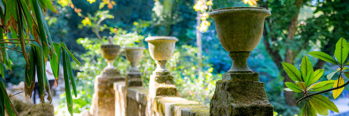 Antique concrete pot, cement vase as decoration in garden