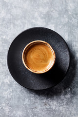 Cup of coffee on rustic wooden background. Top view. Copy space.