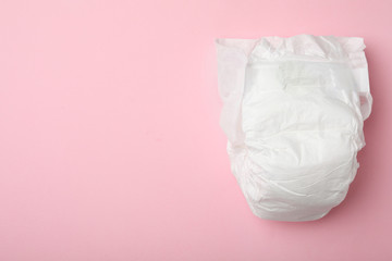 Baby diaper on pink background, top view. Space for text
