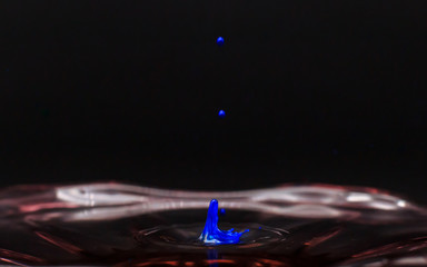Blue color water drop and splash in clear water
