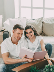 young couple looking for a family photo in a new apartment.