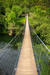 Fototapeta na wymiar Suspension bridge over the Paiva river, on the Paiva Walkways, near Arouca in Portugal.