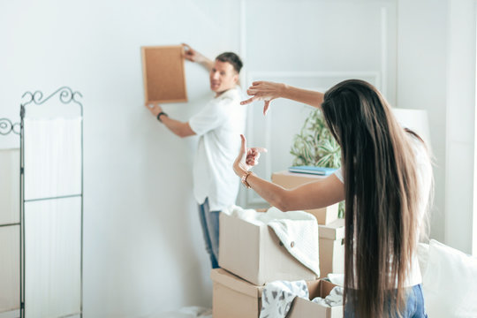 young couple arranging things in their new apartment .