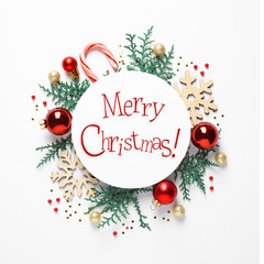 Fototapeta na wymiar Flat lay composition with text MERRY CHRISTMAS and festive decor on white background