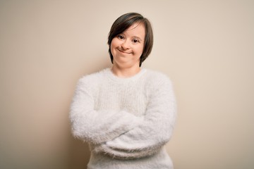 Young down syndrome woman standing over isolated background happy face smiling with crossed arms...