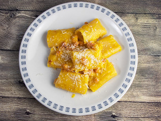 Carbonara paccheri pasta with bacon, eggs, pepper and pecorino cheese 