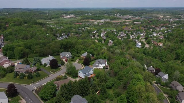 A slow summer aerial flyover establishing shot of a typical Western Pennsylvania residential neighborhood. Pittsburgh suburbs.  	