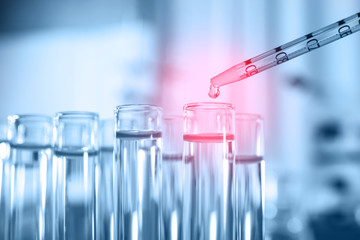 Dripping reagent into test tube, closeup. Laboratory analysis