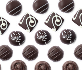Set with different chocolate candies on white background, top view