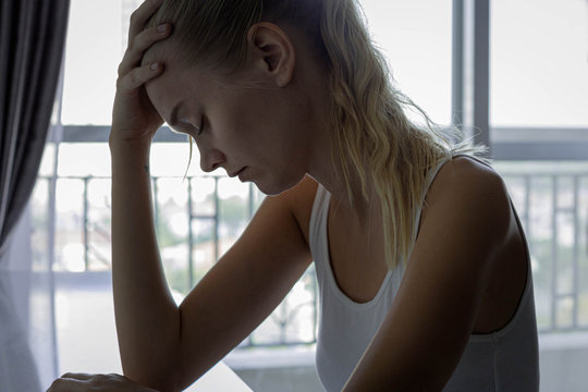 Depressed Sad Woman Sitting At Home Alone.