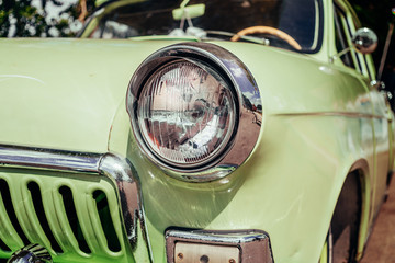 Headlamp of tuned old vintage car, close up. Low rider auto.