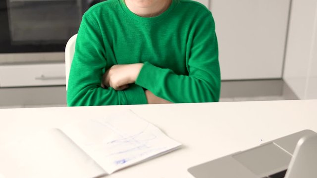 Angry girl drawing scribbles in her homework notebook, volatile behavior