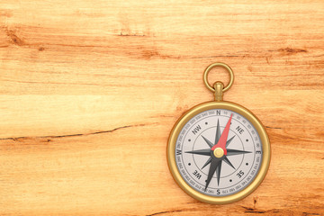 Gold compass on wooden board background. 3D illustration.