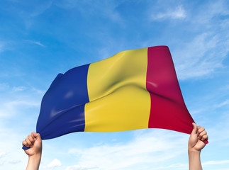 Two hands are holding a Romania flag - flowing through the wind. 3D Illustration.