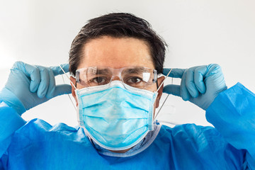 Doctor putting on a face mask