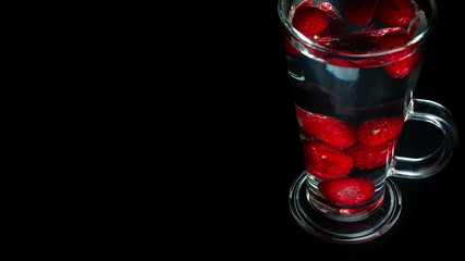 
Raspberries in a water glass. Free entry space.
