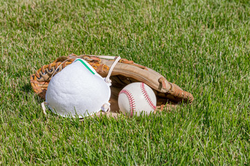 Baseball glove, ball and N95 respirator mask. Concept of reopening America sporting and...