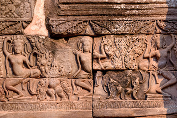 Stone carvings on the walls of the Bayon Temple in Angkor Thom