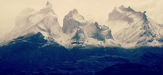 Mountain peaks of Torres del Paine in Patagonia National Park Chile, peaks covered in fog. 