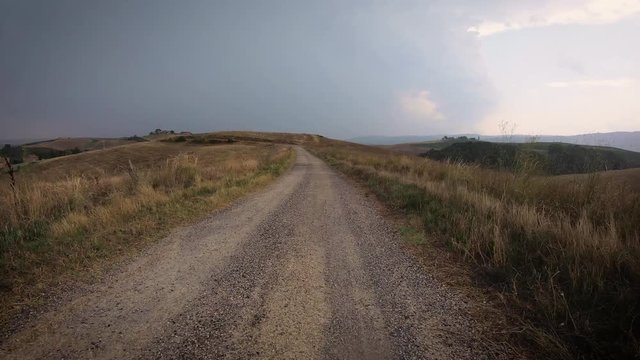 a gravel road on a rainy summer day next to Torrenieri,  Montalcino, Province of Siena, Tuscany, Italy