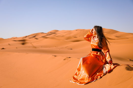 A girl in a beautiful Moroccan dress. Merzouga Morocco.