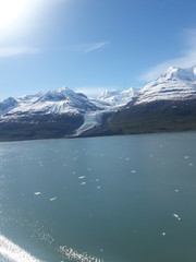 Fototapeta na wymiar Alaska glacier, lake, mountains, snow and blue sky on a sunny day