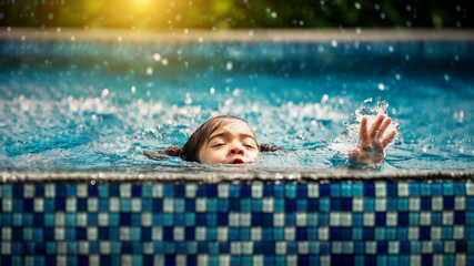 Baby girl drowning in pool. Danger and children Concept. Pools and swimming lessons. - obrazy, fototapety, plakaty