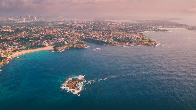 Aerial view of Sydney coastline from above with Sydney CBD in the background
