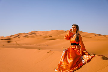 A girl in a beautiful Moroccan dress. Merzouga Morocco.