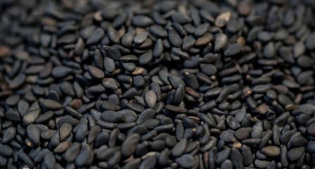 black sesame seeds on wood background
