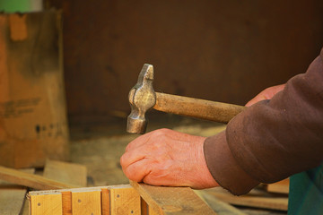 man hammering nails