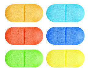 Set of red, blue, green and yellow medical pill tablet isolated on white