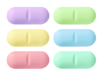 Set of red, blue, green and yellow medical pill tablet isolated on white