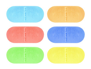 Set of red, blue, green and yellow medical pill tablet isolated on white