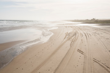 Beach with foot prints and truck tracks, at sunset; in Cabo Polonio, Uruguay