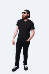 Full length photo of young bearded hipster man standing