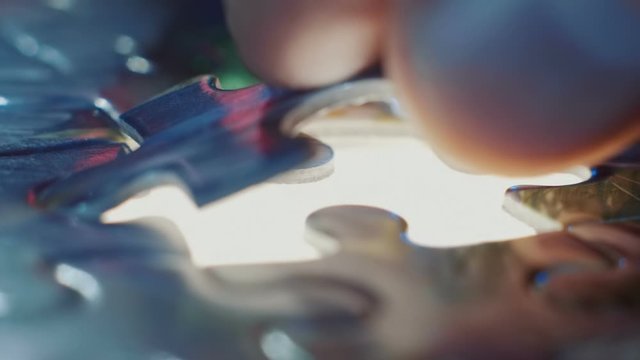 Install the last puzzle element to the place highlighted below. Macro. Closeup. Shallow depth of field. Slow motion. High speed camera