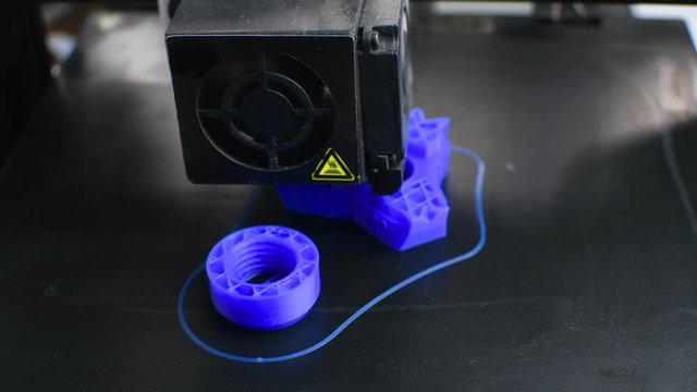 The 3D printer printed blue plastic model. modern technology