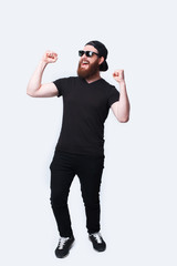 Full length photo of amazed bearded hipster man celebrating success
