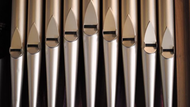 Close up and tilt of old musical intrument pipe organ tubes.