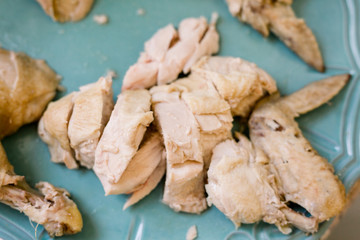 Hainanese Chicken Chopped Up on a Blue Platter