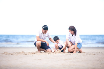 Fototapeta na wymiar Active parents and people outdoor activity on summer vacations and holiday with children.Happy family and son walk with fun of sunset sea on sand beach.