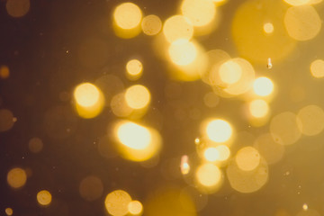 Fototapeta premium Dark Abstract Gold bokeh sparkle on black background