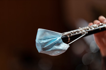An oboe equipped with a face mask to prevent potentially blowing a virus on other musicians in...